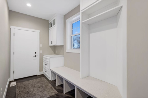 Mudroom off garage entrance, plenty of space to hang coats and store shoes