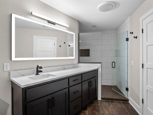 Full LL Bath with separate tub and shower, lighted mirror