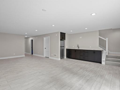 Refrigerator, wet bar, cabinetry - perfect for hosting movie or game night