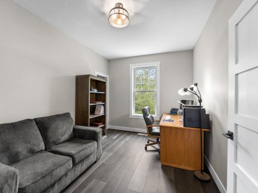 Main level office is well lit and has beautiful views of trees