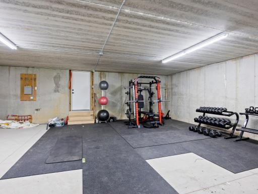 Lower level garage currently serving as workout room