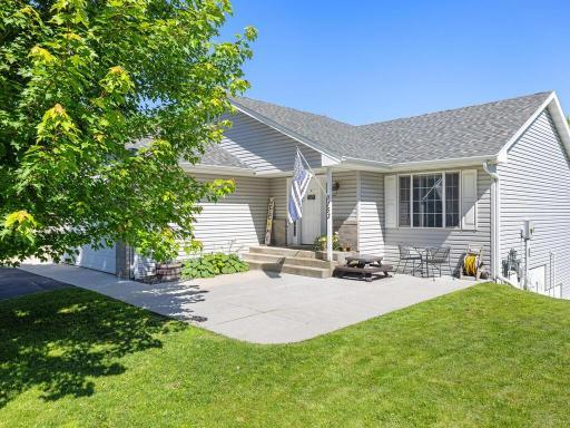 Large, welcoming front concrete patio area