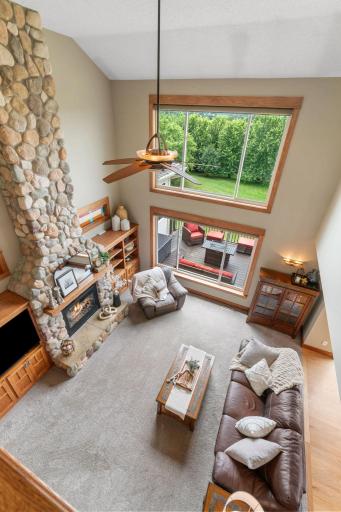 Bright, open Main Level w/ soaring 2-story ceilings & floor-to-ceiling stone fireplace