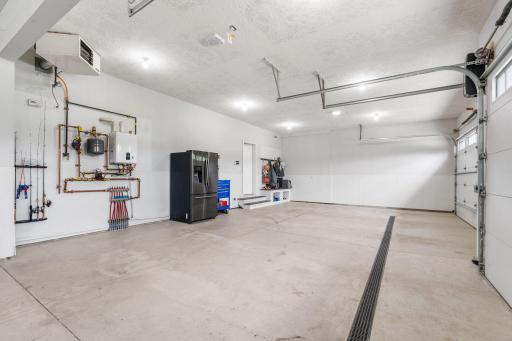 DREAM 5-car heated garage w/ $200K addition, drain, storage loft & LiftMaster system