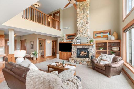 Bright, open Main Level w/ soaring 2-story ceilings & floor-to-ceiling stone fireplace