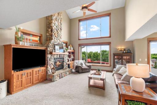 Bright, open Main Level w/ soaring 2-story ceilings & floor-to-ceiling stone fireplace