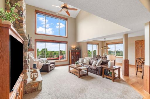 Bright, open Main Level w/ soaring 2-story ceilings & floor-to-ceiling stone fireplace