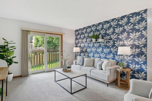 Charming living room with floral accent wall, brand new carpeting, and sliding glass doors for a future deck to the backyardâbringing in natural light and seamless indoor-outdoor flow.