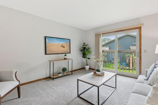 Bright and versatile upper-level living space featuring neutral tones, updated carpet, and a cozy overlook to the main levelâperfect for a reading nook or lounge area.