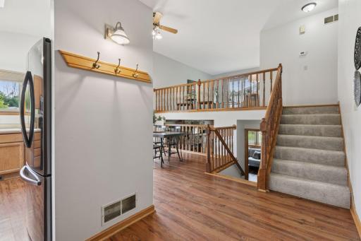 Welcoming split-level entry with views into multiple living spaces. Luxury vinyl plank flooring adds warmth and durability, while the open layout provides a bright and connected flow throughout the home.