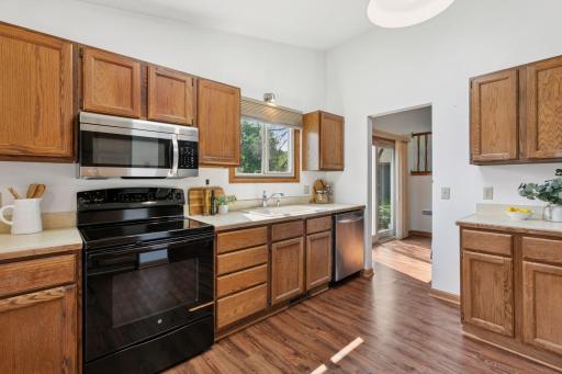 Bright and functional kitchen with natural wood cabinetry, stainless steel appliances, and a skylight that fills the space with natural lightâperfect for everyday cooking and entertaining.