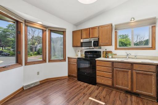 Bright and functional kitchen with natural wood cabinetry, stainless steel appliances, and a skylight that fills the space with natural lightâperfect for everyday cooking and entertaining.