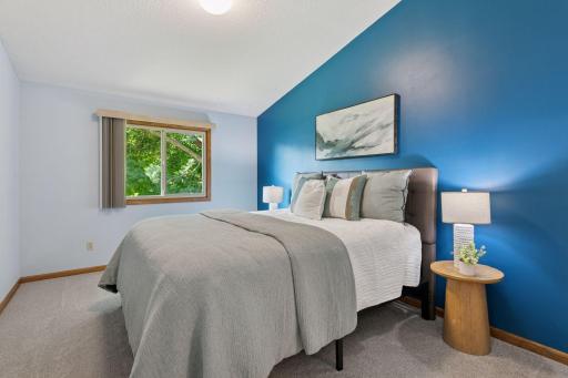Primary bedroom retreat with vaulted ceilings and plenty of room for a king bed, seating area, or more.