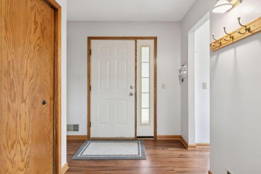 Welcoming split-level entry with views into multiple living spaces. Luxury vinyl plank flooring adds warmth and durability, while the open layout provides a bright and connected flow throughout the home.