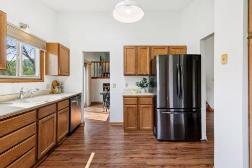 Bright and functional kitchen with natural wood cabinetry, stainless steel appliances, and a skylight that fills the space with natural lightâperfect for everyday cooking and entertaining.
