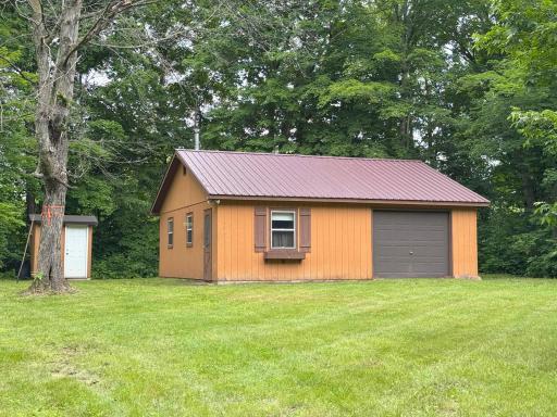 A look at the garage/bunkhouse from the level yard, with nice tree privacy from the neighbors on both side and at the back of the lot.