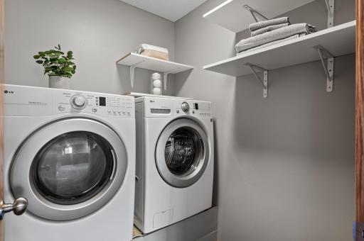 Upper level laundry room has some great shelving plus a linen closet right outside the room.