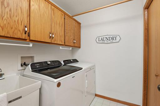 Laundry room with storage, and utilities.