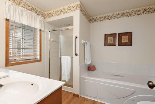 Primary bathroom has a large tub and a shower.