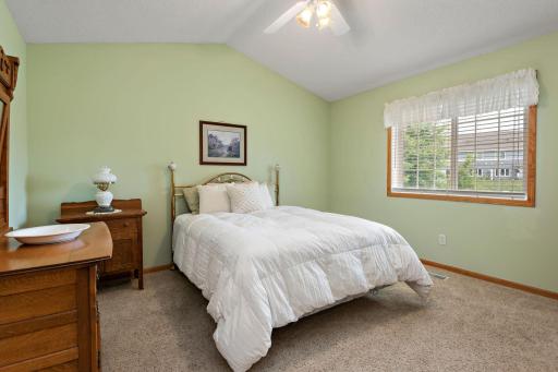 Primary bedroom with vaulted ceiling, private bath and walk-in closet.