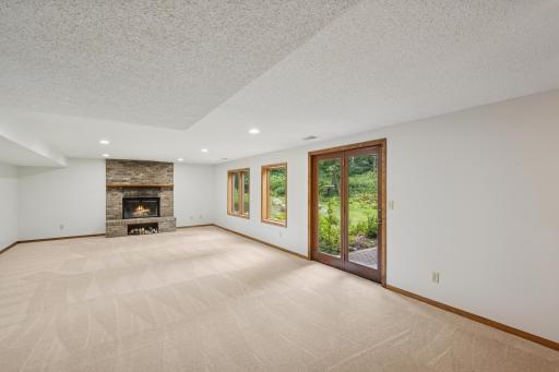Walk-out amusement room has a charming brick wood burning fireplace