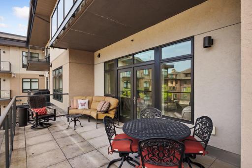 This unit has two balcony decks. The larger one has ample room for sofa and outdoor dining table and chairs and has doorway leading to both the primary bedroom suite and to the living room.
