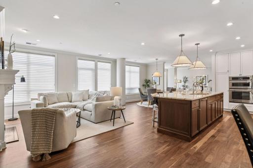 The kitchen is open to the great room with its walls of windows and exterior door to the smaller balcony with grill.