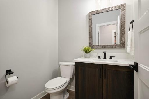 Powder room on the main level between the laundry room and kitchen.