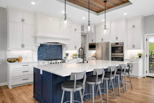 Simply stunning. Undercabinet lighting highlights the backsplash and countertops, and the gorgeous glass pendant light fixtures compliment the glass staircase light fixture.