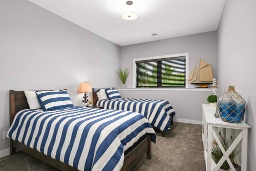 Bedroom #5 on the lower level. Both bedrooms are by one of two 3/4 bathrooms on this level.