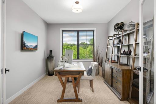 Main level home office with glass French doors.