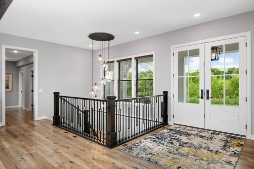 Gorgeous details throughout like this elegant glass light fixture over the stairway.