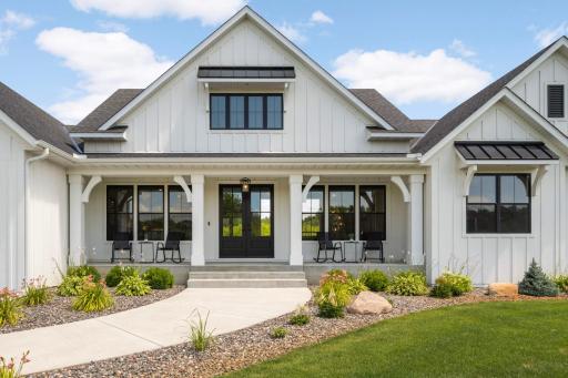 Spacious 33'x6' concrete patio welcomes you are you walk up to this stunning modern farmhouse.