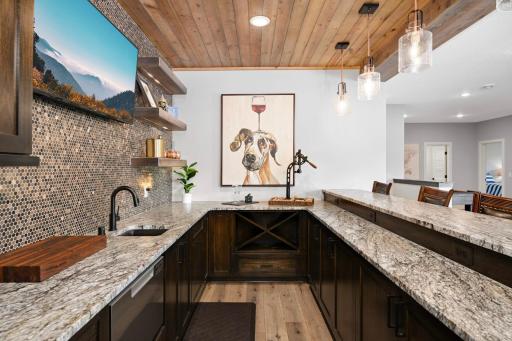 Dream wet bar! Gorgeous 14' leathered granite matte countertop, and penny tiled backsplash.