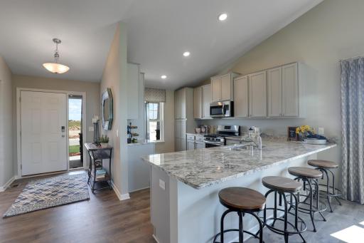 Open concept living at it's best with the vaulted main level ceilings! Photos of model home. Colors and options may vary. Ask Sales Agent for details.
