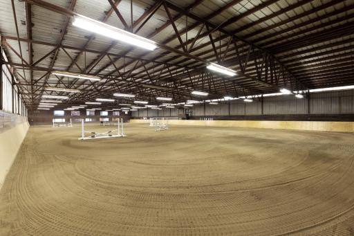 100' x 200' heated Indoor Arena - Steel Construction - 6' observation aisle on north side of indoor - Footing: fine to medium sand with sub-angular particles over an aglime base. New sideboards Nov 2025