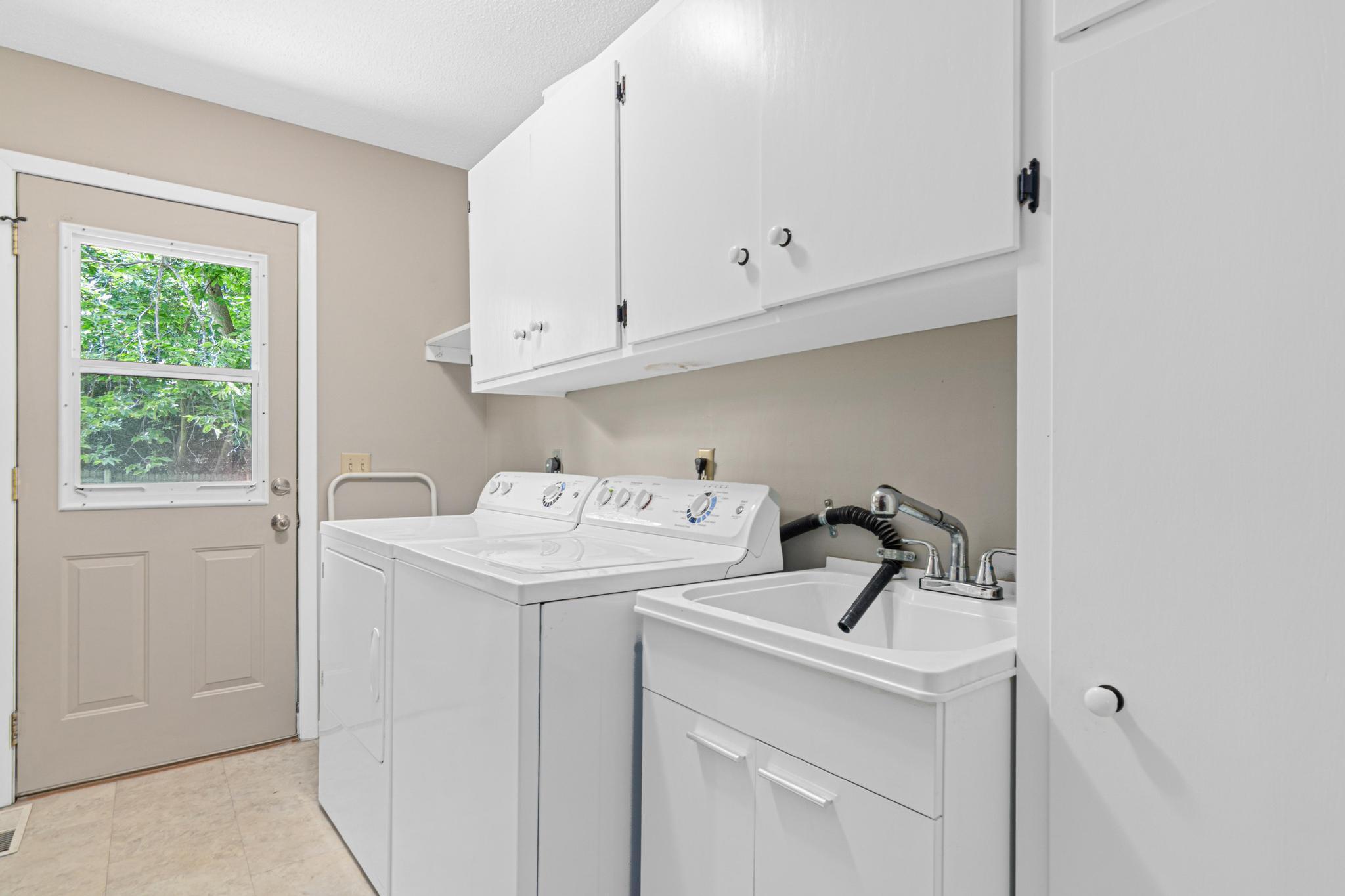 Spacious Upper Level Laundry Room With Backyard Access!