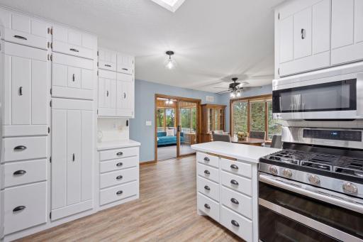 Additional view of the kitchen overlooking the dining room and 4 season porch,