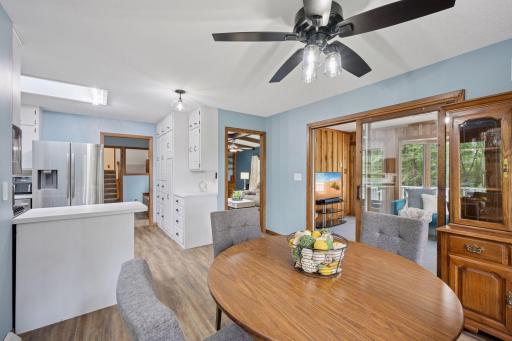 This view of the dining room overlooks the kitchen, walkthrough to the living room and 4 season porch