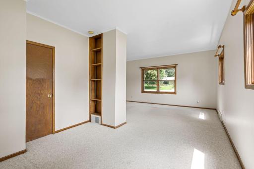 Built in bookshelf in den and view out of living room windows to Grove
