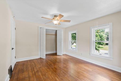 Refinished wood floors, ceiling fan and closet