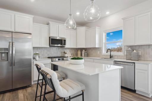 (*Photo of decorated model, actual homes colors and finishes will vary) Enjoy plenty of cabinet space in the spacious kitchen