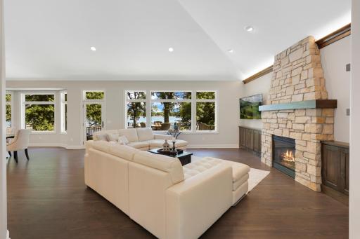 Custom stone fireplace with custom alder built-ins, mantel accent lighting and floating shelves
