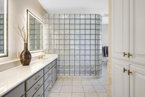Owners en suite includes and 9 ft vanity with Cambria vanity top and brushed gold detail