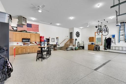 Three car garage that has ceiling access point for large full height storage area above the garage.