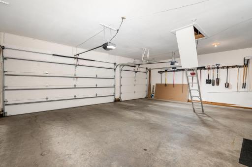 This insulated, finished 3 car garage offers 724 sqft! & pull-down attic storage. It features updated: Chamberlain SMART garage door openers w/2 outside keypads; ceiling-mounted storage (not pictured); and wall tool organizers throughout.