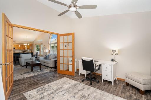 The main floor office features: double French doors, a vaulted ceiling, and updated: flooring, paint, door hardware, & ceiling fan. Newer sliding glass door (2020 - not pictured) leads to 11.9x13 deck (maintenance free boards & railing in 2020).