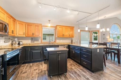 3 of the kitchen cabinets offer convenient, pull out drawers for: pots & pans and baking dishes. The corner, lazy Susan (with spinning shelves) also provides additional storage. The black, center island cart is included.