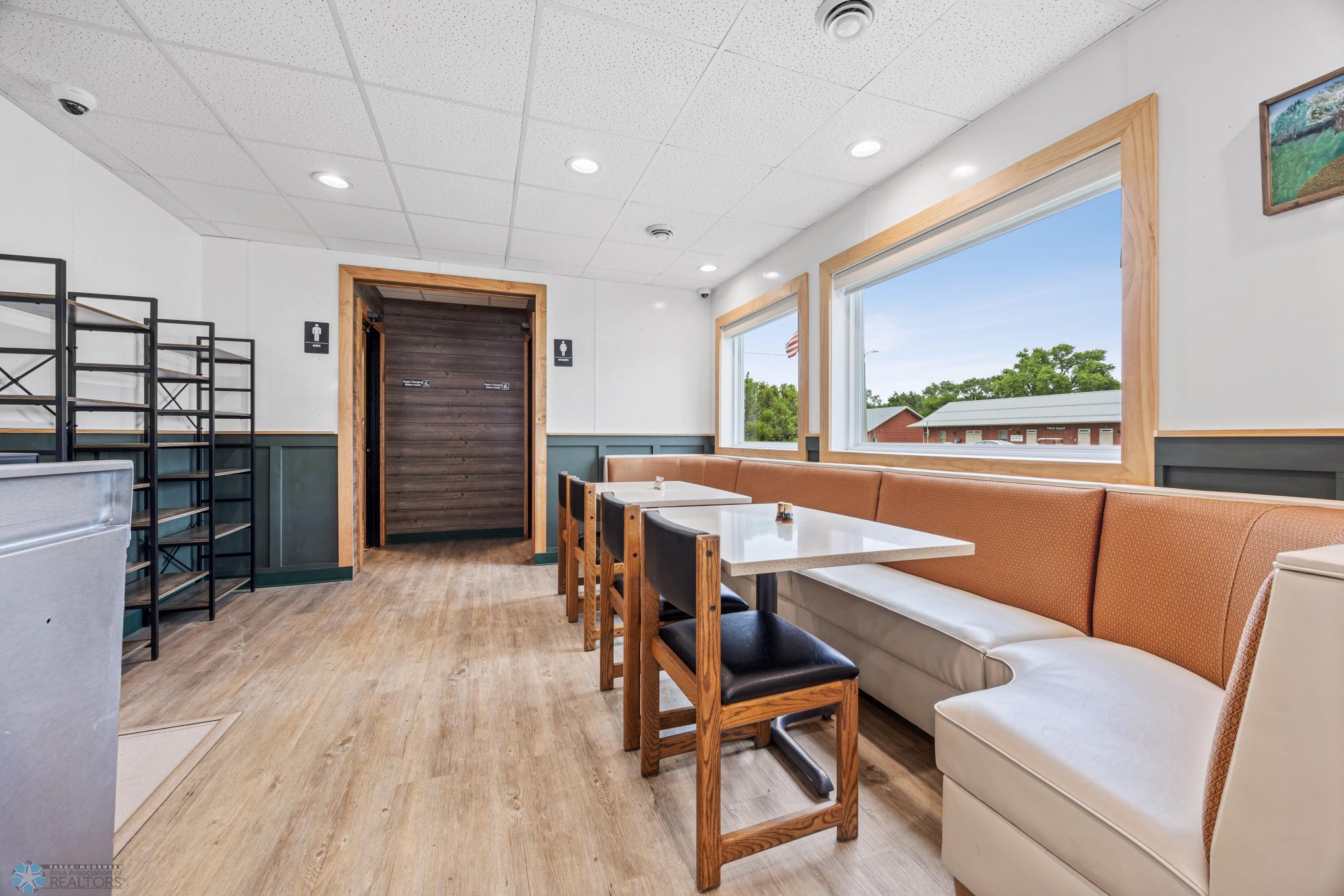 Front sitting area; newer large windows with window coverings; updated flooring