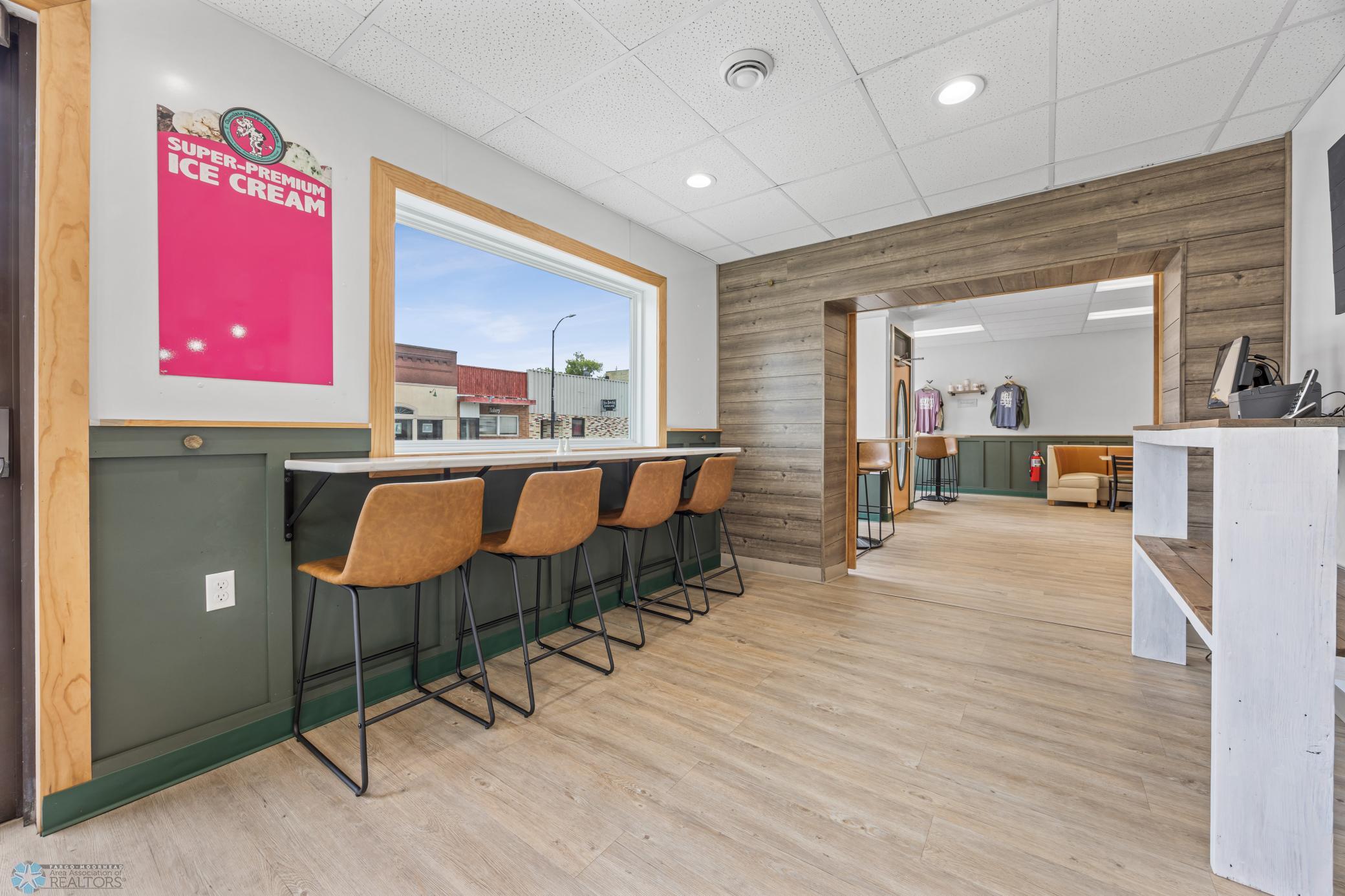 Bar height sitting overlooking Main Street and entry into additional seating area